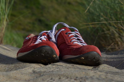 Close-up of shoes on rock