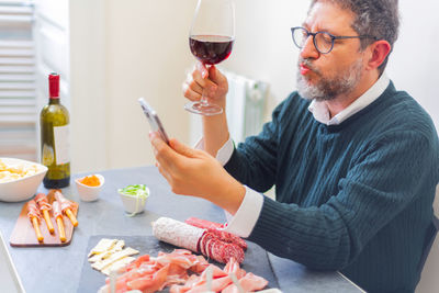 Man drinking wine at home