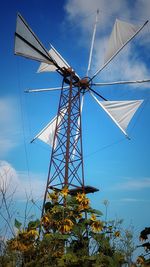 Low angle view of windmill against blue sky