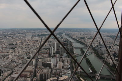 High angle view of city buildings against cloudy sky