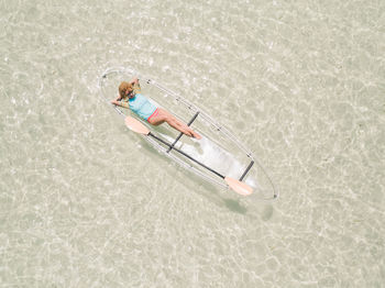 High angle view of woman on inflatable boat in sea