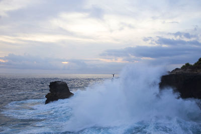 View of waves crashing on rock at sea