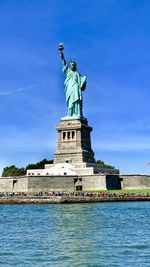 Statue of liberty against blue sky