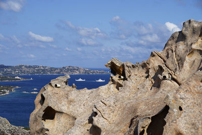 Panoramic view of rocks on beach against sky