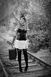 Full length of woman standing on railroad track