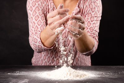 Midsection of woman holding water