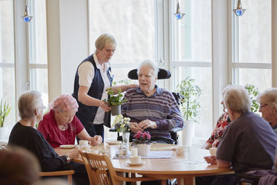Senior people having coffee in care home