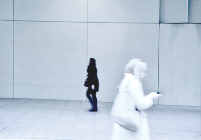 Side view of people walking on floor in city