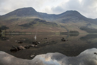 Scenic view of lake and mountains against sky