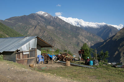 Cabin on mountain against sky