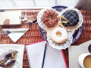 High angle view of donuts in plate on table