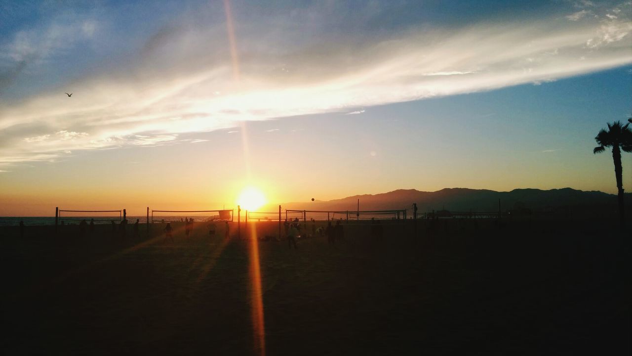 sun, sunset, scenics, tranquil scene, tranquility, sky, silhouette, sunbeam, beauty in nature, sunlight, sea, lens flare, nature, idyllic, beach, landscape, water, cloud - sky, mountain, horizon over water