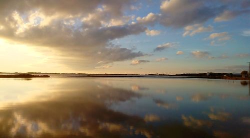 Scenic view of lake against sky during sunset