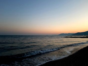 Scenic view of sea against clear sky during sunset