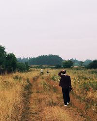 Woman standing on grassy field