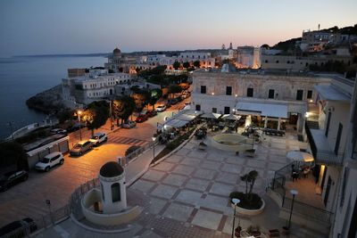 High angle view of buildings by sea against sky