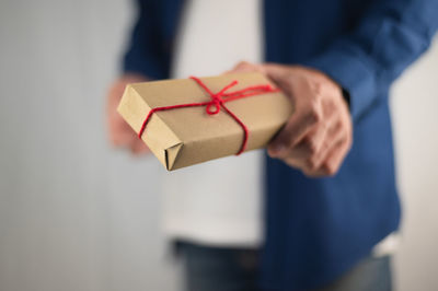 Midsection of man holding small in box