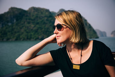 Close-up of a young woman looking at view of water