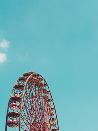 Low angle view of ferris wheel against clear sky