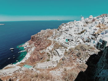 High angle view of sea and buildings against sky