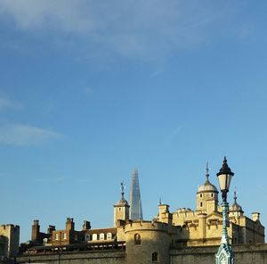 Low angle view of shard london bridge with church in foreground