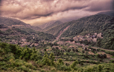 Scenic view of mountains against cloudy sky