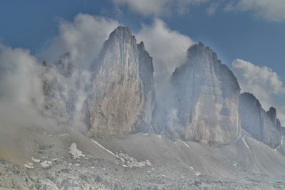 Low angle view of clouds over snow covered landscape