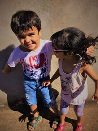 Cheerful siblings standing outdoors