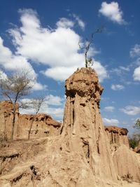 Low angle view of rock formations against sky