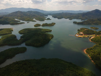 High angle view of lake and mountains against sky