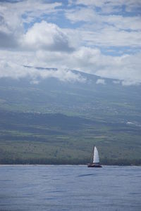 Sailboat sailing on sea against sky