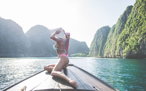 Woman on longtail boat in sea