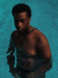 Portrait of shirtless man in swimming pool