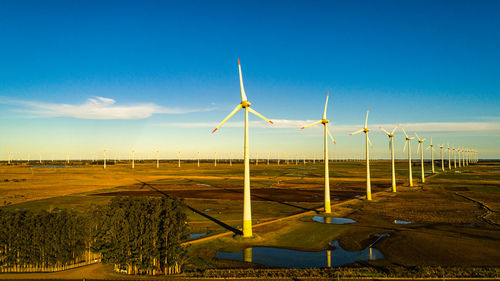 Windmill on field against sky