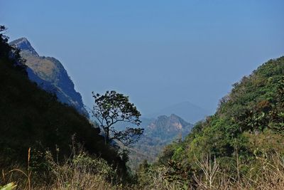 Scenic view of mountains against blue sky