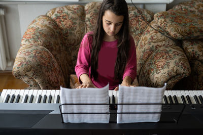 Portrait of young woman using laptop at home