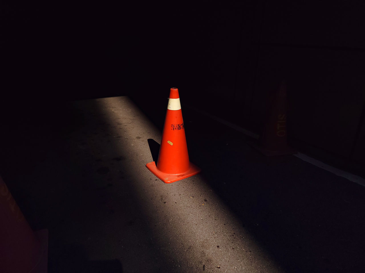 red, darkness, traffic cone, cone, light, night, lighting, sign, no people, guidance, warning sign, security, yellow, communication, protection, road, black, shadow, illuminated, white, orange color, architecture