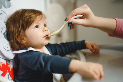 Cropped hand of dentist examining patient at clinic