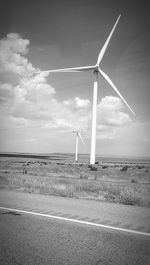 Windmill on field against sky