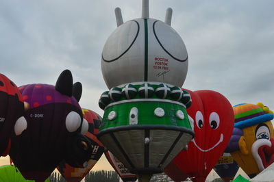 Low angle view of carousel against sky