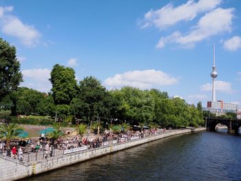 People in park by city against sky
