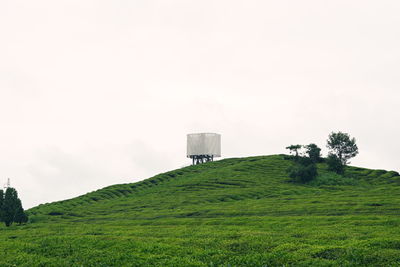 Built structure on field against clear sky