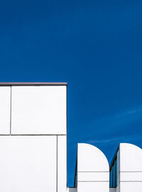 High section of building against clear blue sky