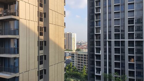 Buildings in city against sky