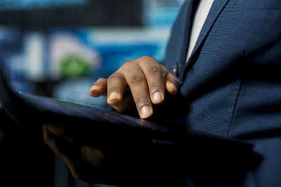 Midsection of businessman using mobile phone
