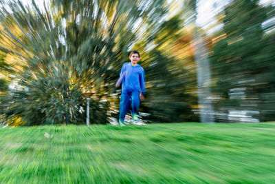 Full length rear view of man on grass