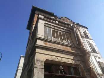 Low angle view of old building against blue sky