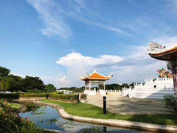 View of swimming pool by lake against sky