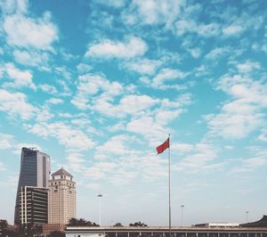 View of cityscape against cloudy sky