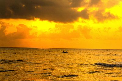 Scenic view of sea against orange sky